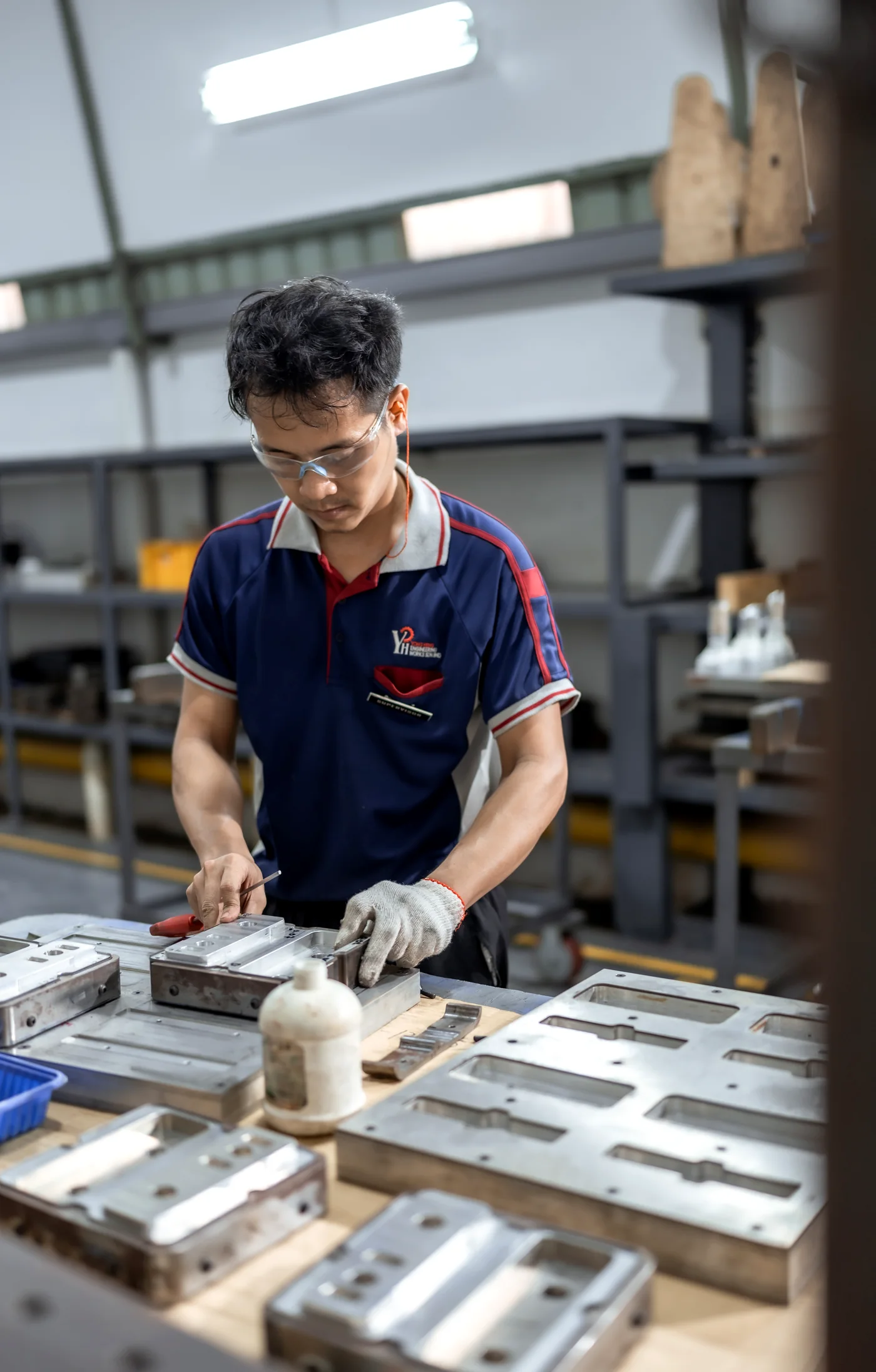 A Yong Heng fitter assembling a mold plate.