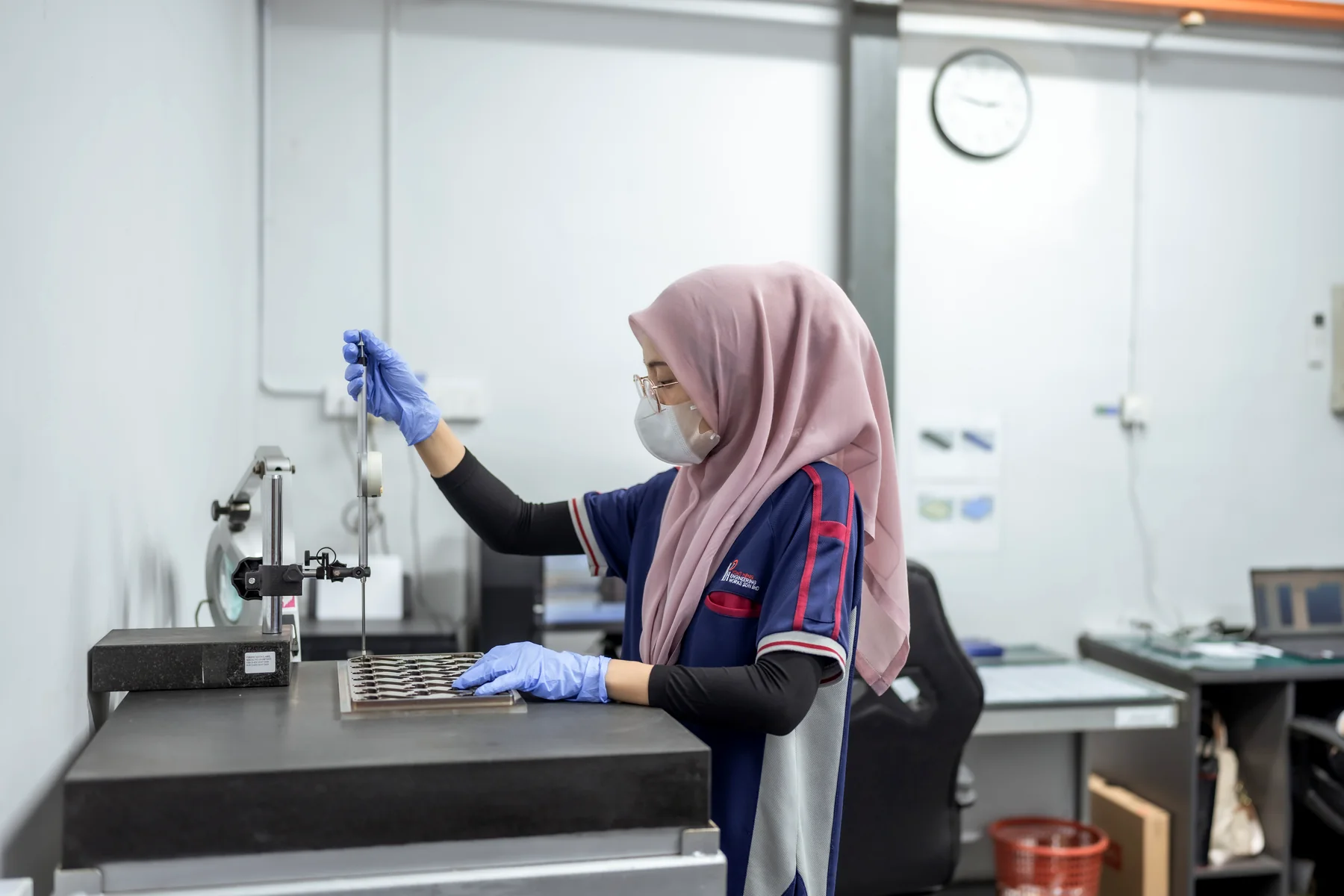 A Yong Heng quality inspector measuring a mold insert on a granite surface plate.